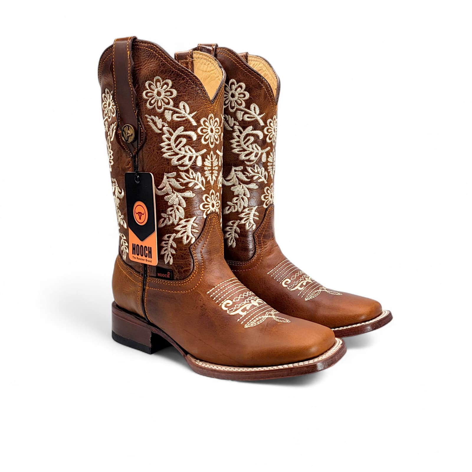 Pair of brown cowboy boots with white embroidery on a white background